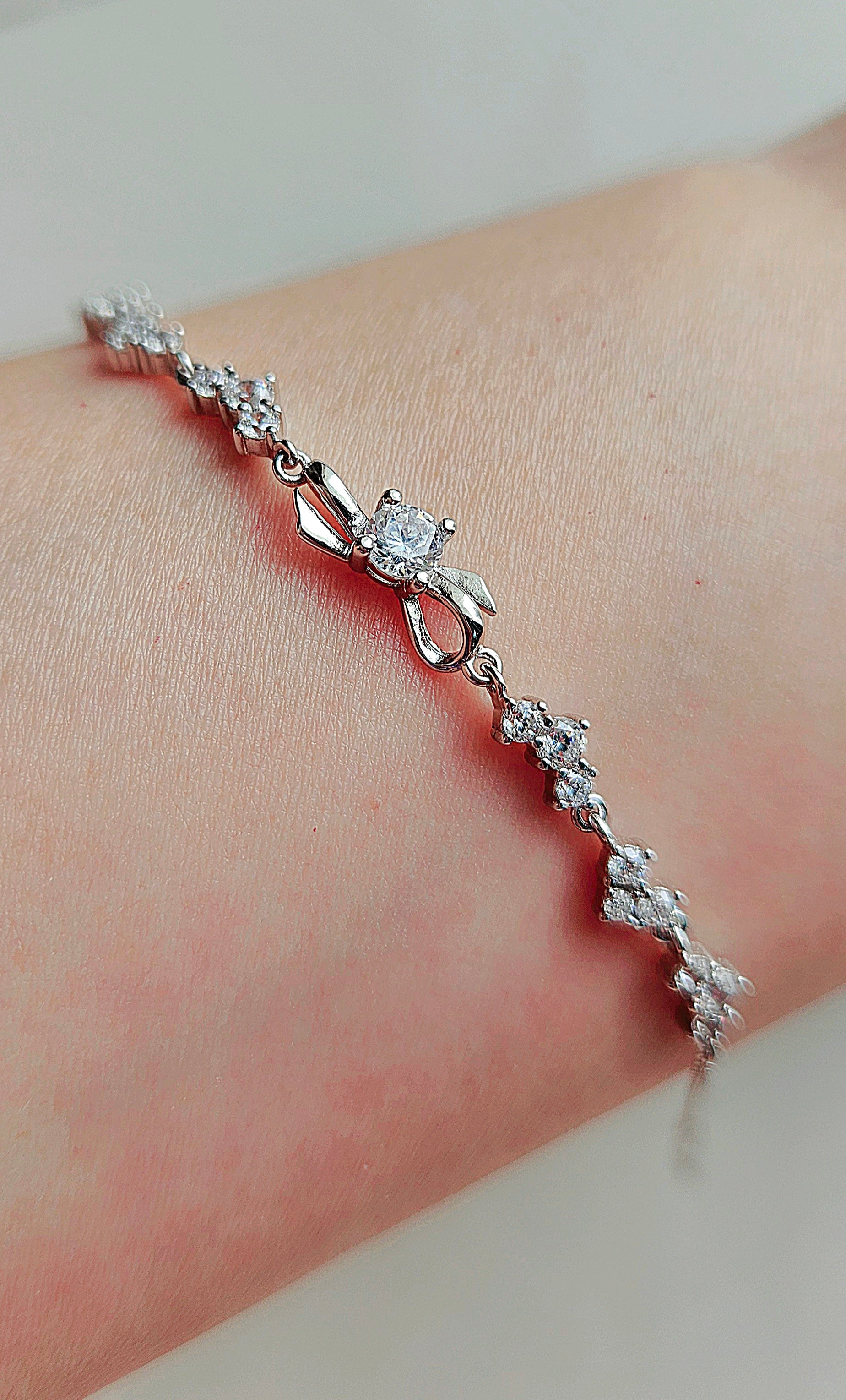 925 STERLING SILVER BOW BRACELET CRUSTED WITH CUBIC ZIRCONIA STONES