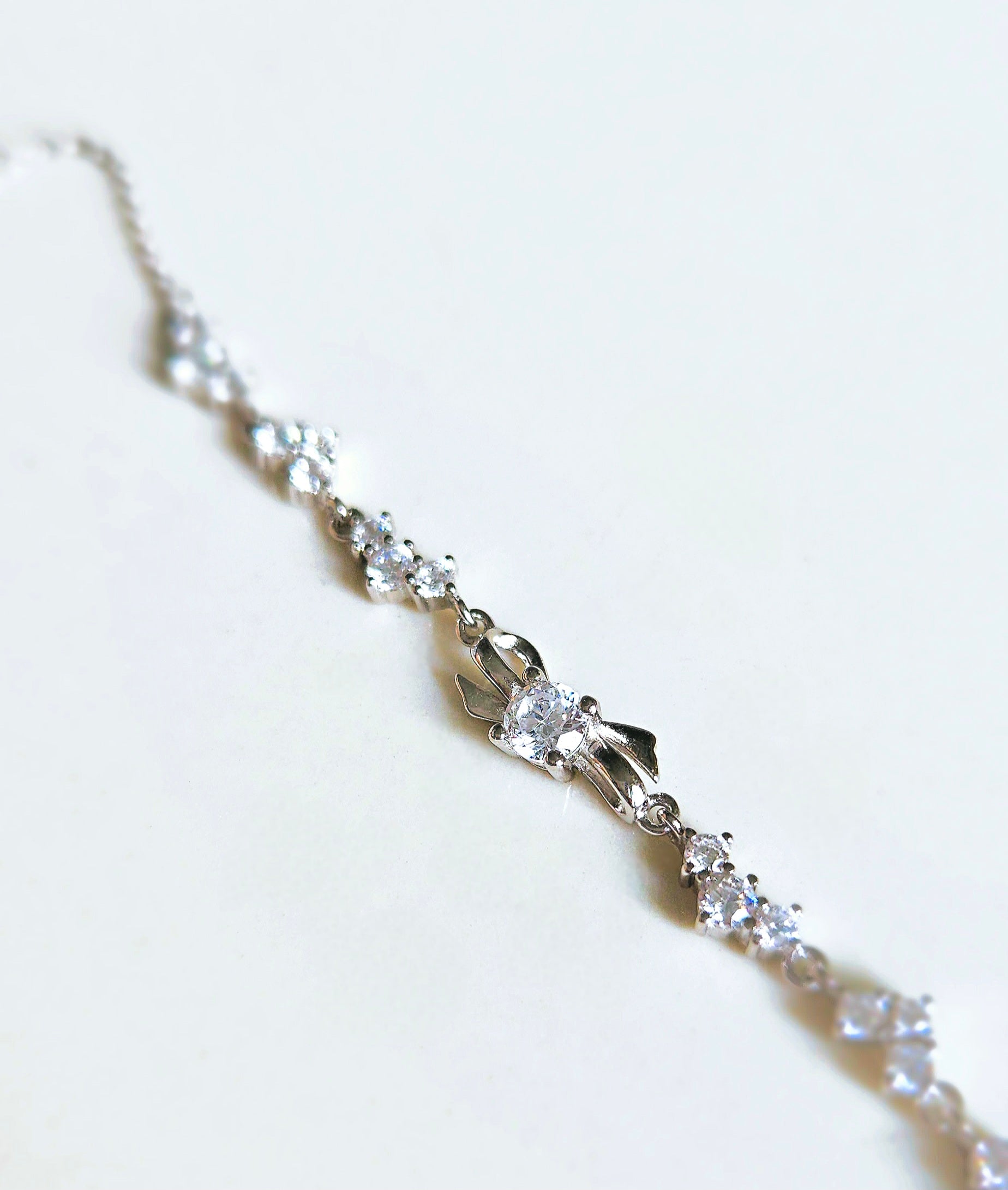 925 STERLING SILVER BOW BRACELET CRUSTED WITH CUBIC ZIRCONIA STONES