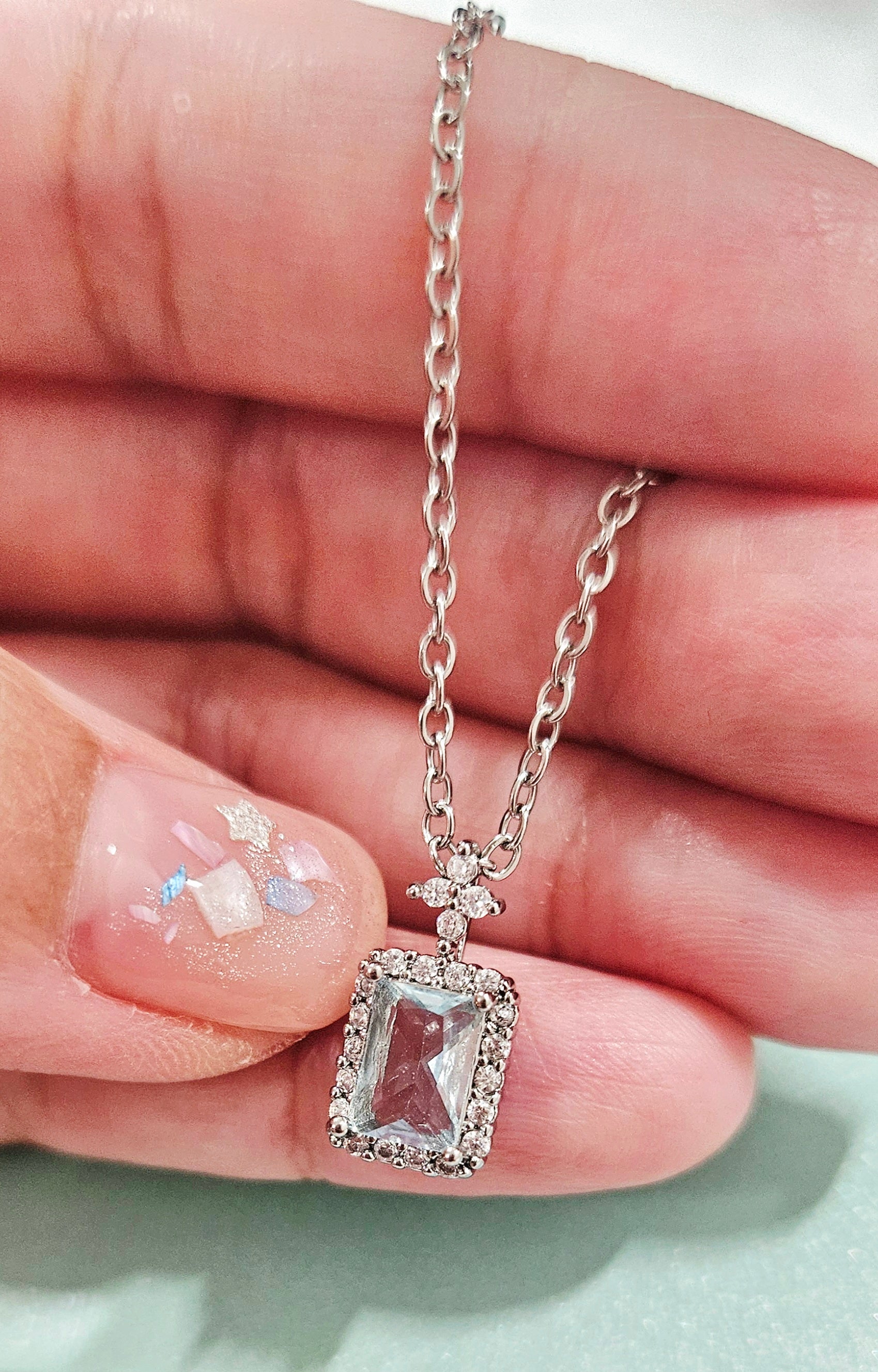 STAINLESS STEEL NECKLACE WITH AQUA CUBIC ZIRCONIA PENDANT