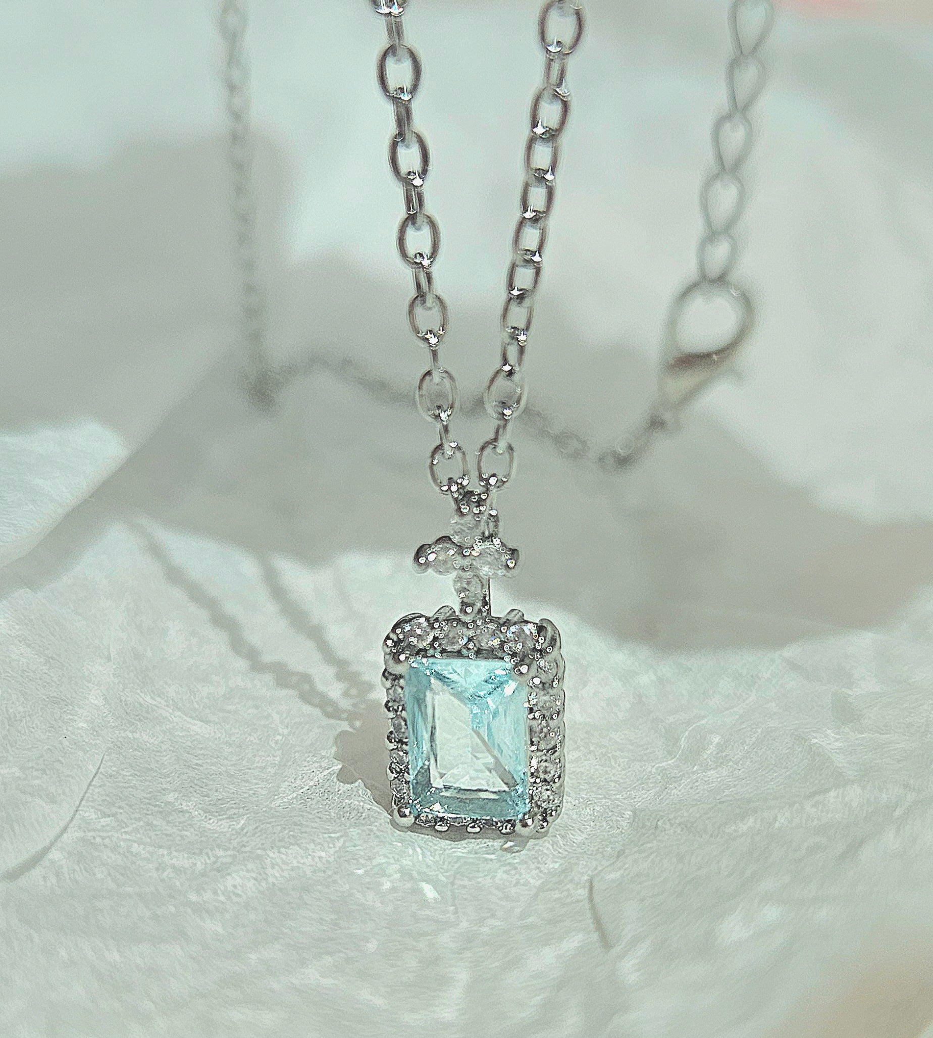 STAINLESS STEEL NECKLACE WITH AQUA CUBIC ZIRCONIA PENDANT
