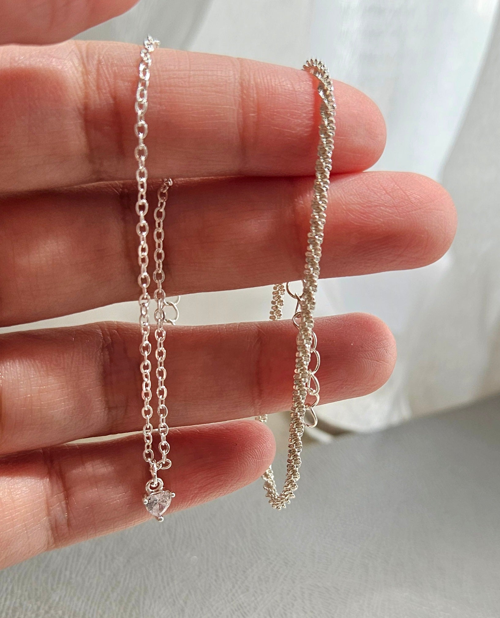 SET OF 2 SILVER BRACELETS & A FAUX PEARL BOW RING