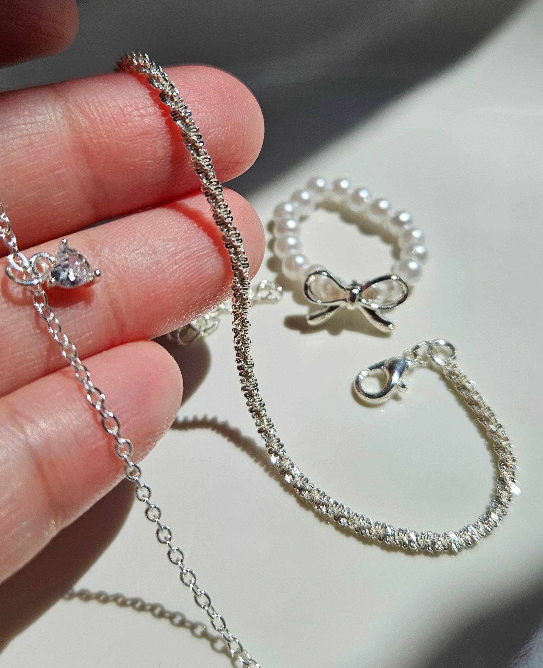 SET OF 2 SILVER BRACELETS & A FAUX PEARL BOW RING