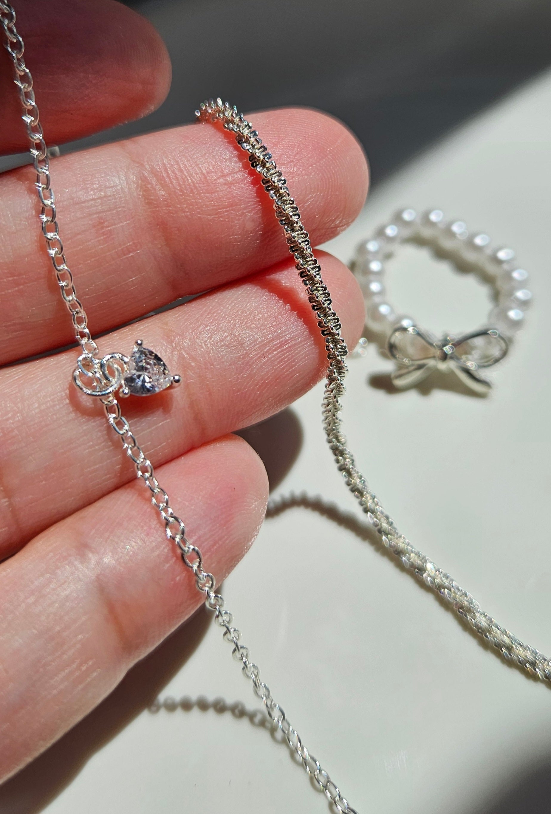 SET OF 2 SILVER BRACELETS & A FAUX PEARL BOW RING