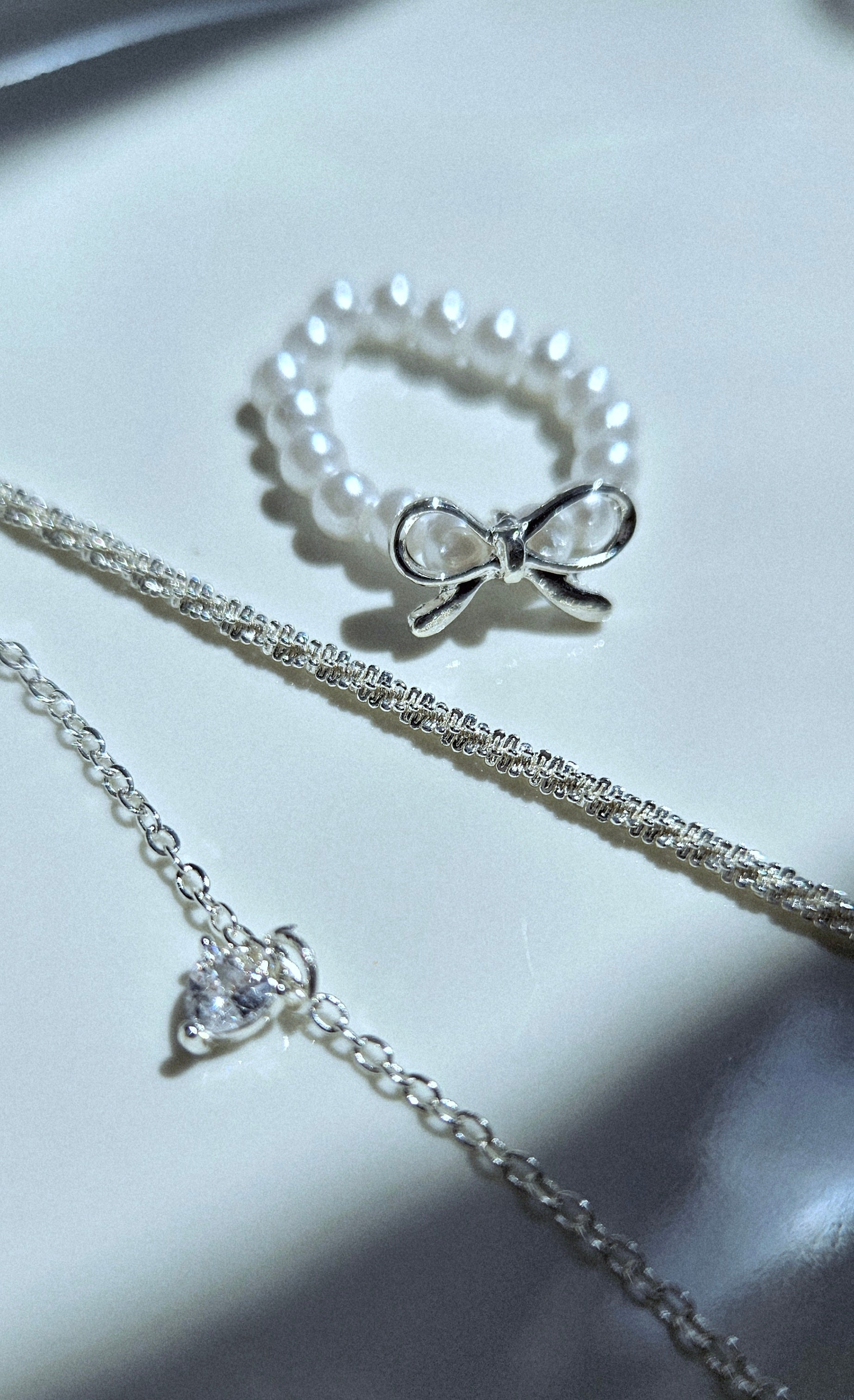 SET OF 2 SILVER BRACELETS & A FAUX PEARL BOW RING