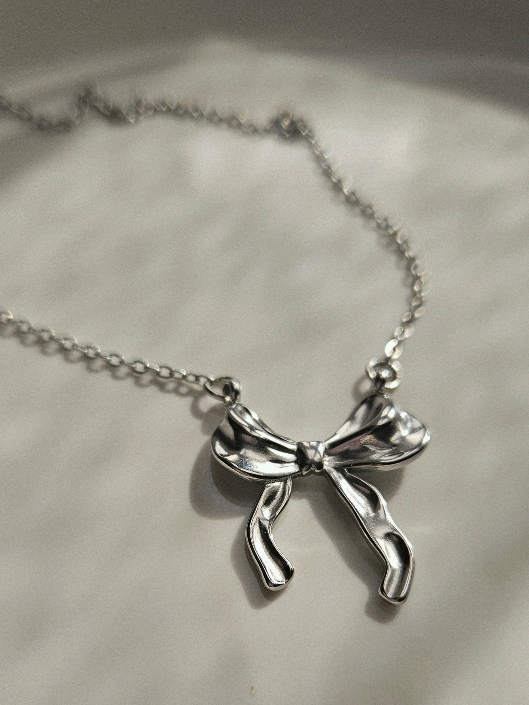 STAINLESS STEEL SILVER BOW EARRINGS AND NECKLACE SET