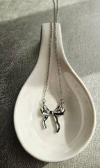 STAINLESS STEEL SILVER BOW EARRINGS AND NECKLACE SET